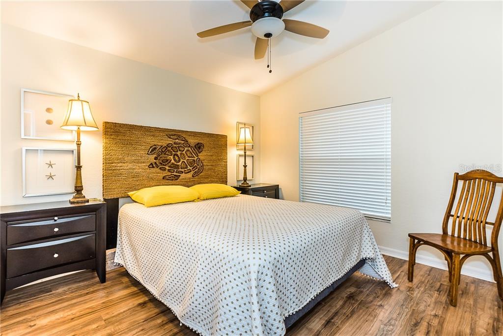 3800 Tripoli Boulevard, Unit 35 Punta Gorda, FL 33950 - Photo 37 of 44 a bedroom with a bed and wooden floor