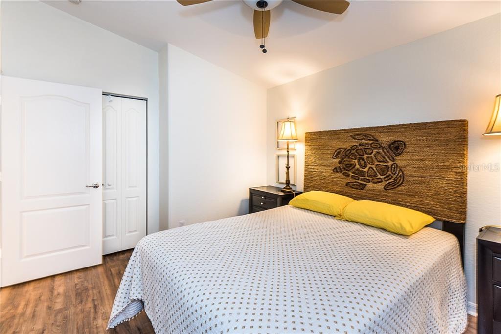 3800 Tripoli Boulevard, Unit 35 Punta Gorda, FL 33950 - Photo 38 of 44 a bedroom with a bed and a painting on the wall