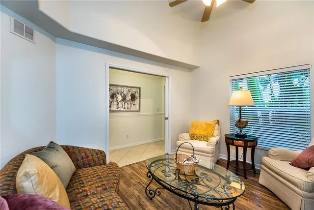 a living room with furniture and wooden floor