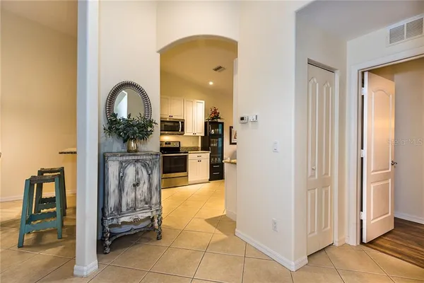 a view of kitchen with stainless steel appliances kitchen island refrigerator and stove