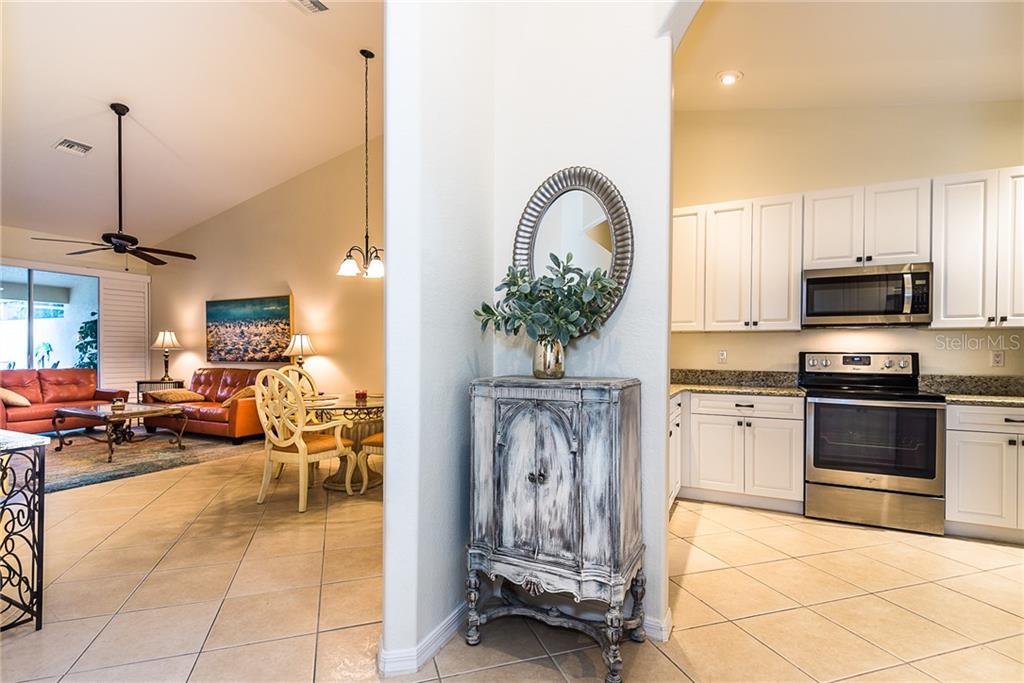 3800 Tripoli Boulevard, Unit 35 Punta Gorda, FL 33950 - Photo 8 of 44 a living room with furniture a fireplace and a flat screen tv