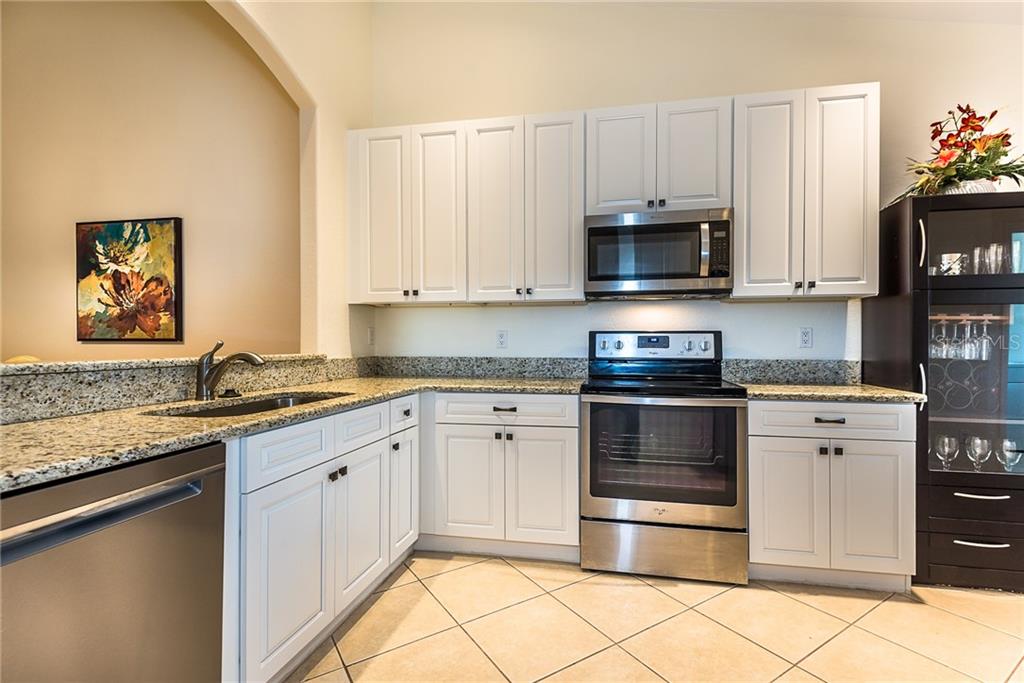 3800 Tripoli Boulevard, Unit 35 Punta Gorda, FL 33950 - Photo 9 of 44 a kitchen with granite countertop a stove and a microwave