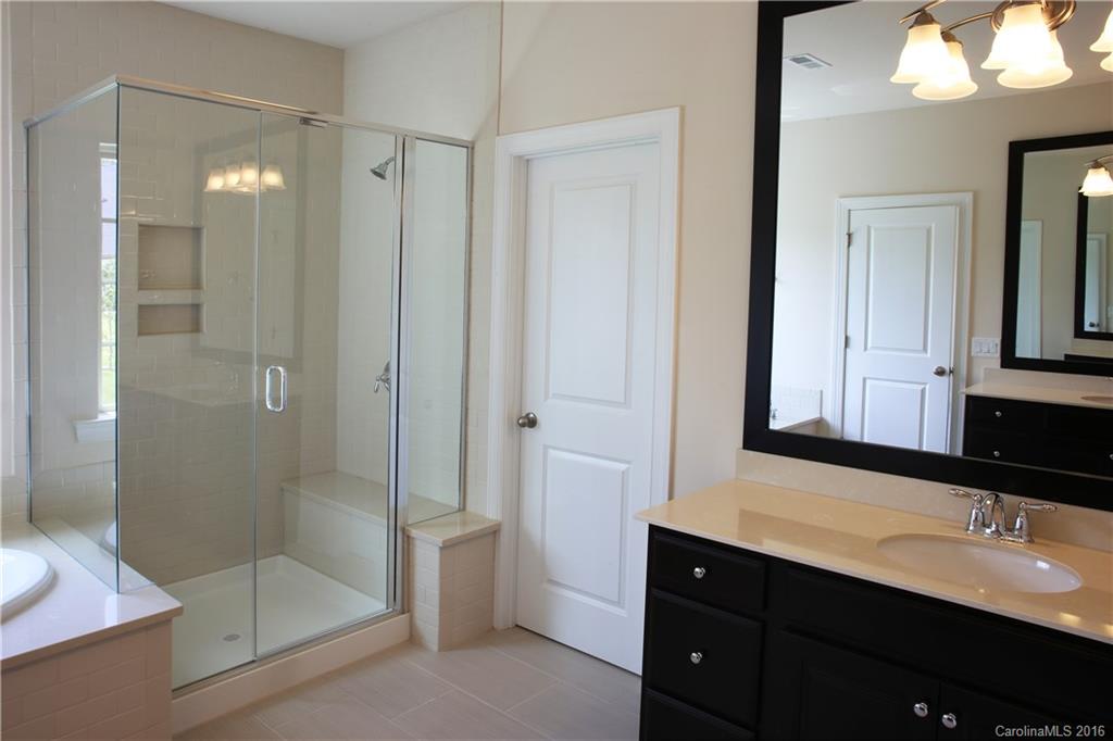 1026 Emory Lane, Unit 74 Fort Mill, SC 29708 - Photo 14 of 23 a bathroom with a shower sink and mirror