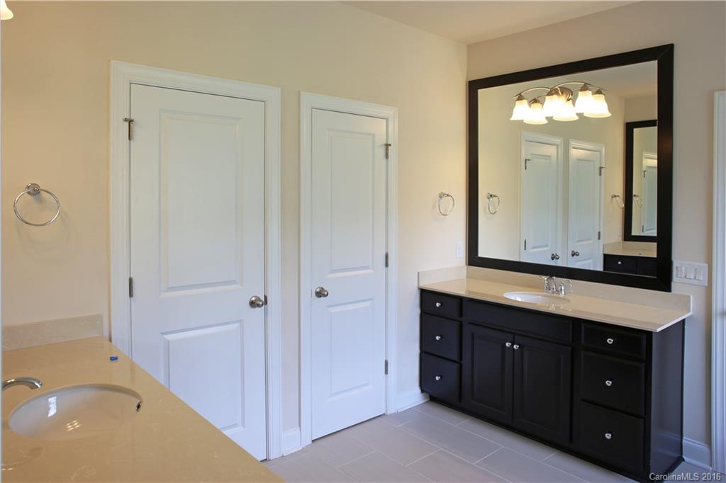 1026 Emory Lane, Unit 74 Fort Mill, SC 29708 - Photo 15 of 23 a bathroom with a tub a double vanity sink and mirror