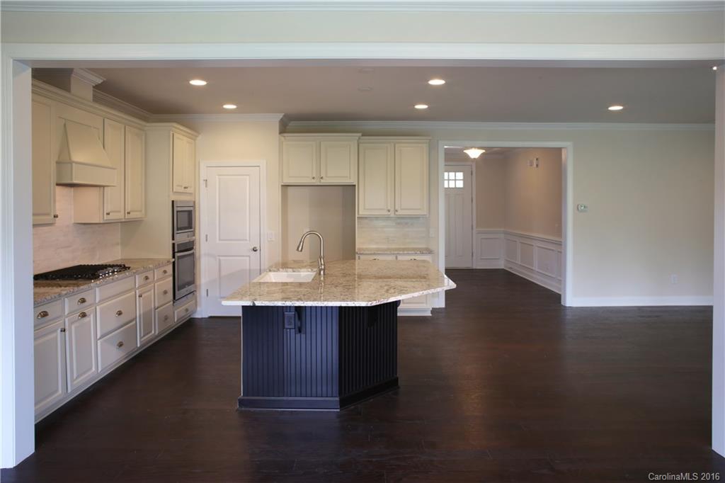 1026 Emory Lane, Unit 74 Fort Mill, SC 29708 - Photo 3 of 23 a kitchen with stainless steel appliances kitchen island granite countertop a stove a sink and a refrigerator