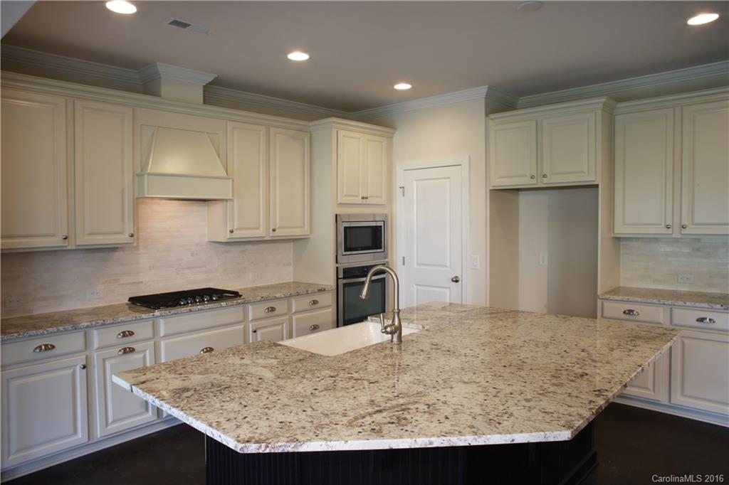 1026 Emory Lane, Unit 74 Fort Mill, SC 29708 - Photo 4 of 23 a kitchen with kitchen island granite countertop a sink a stove and refrigerator