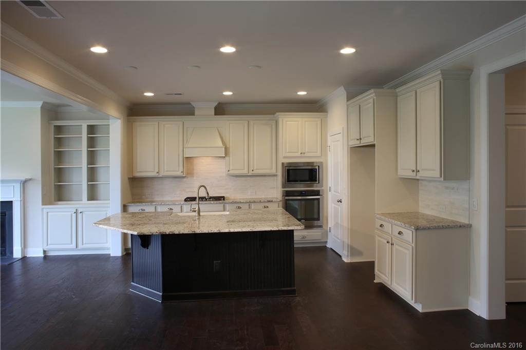 1026 Emory Lane, Unit 74 Fort Mill, SC 29708 - Photo 5 of 23 a kitchen with stainless steel appliances granite countertop a sink dishwasher a stove and a refrigerator with wooden floor