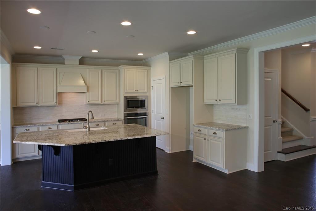 1026 Emory Lane, Unit 74 Fort Mill, SC 29708 - Photo 6 of 23 a kitchen with stainless steel appliances granite countertop a refrigerator a sink dishwasher a stove and white cabinets with wooden floor