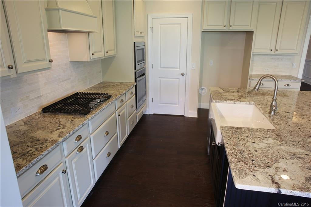 1026 Emory Lane, Unit 74 Fort Mill, SC 29708 - Photo 8 of 23 a kitchen with granite countertop a sink stove and cabinets