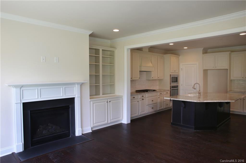 1026 Emory Lane, Unit 74 Fort Mill, SC 29708 - Photo 10 of 23 a kitchen with stainless steel appliances a white stove top oven cabinets and a fireplace