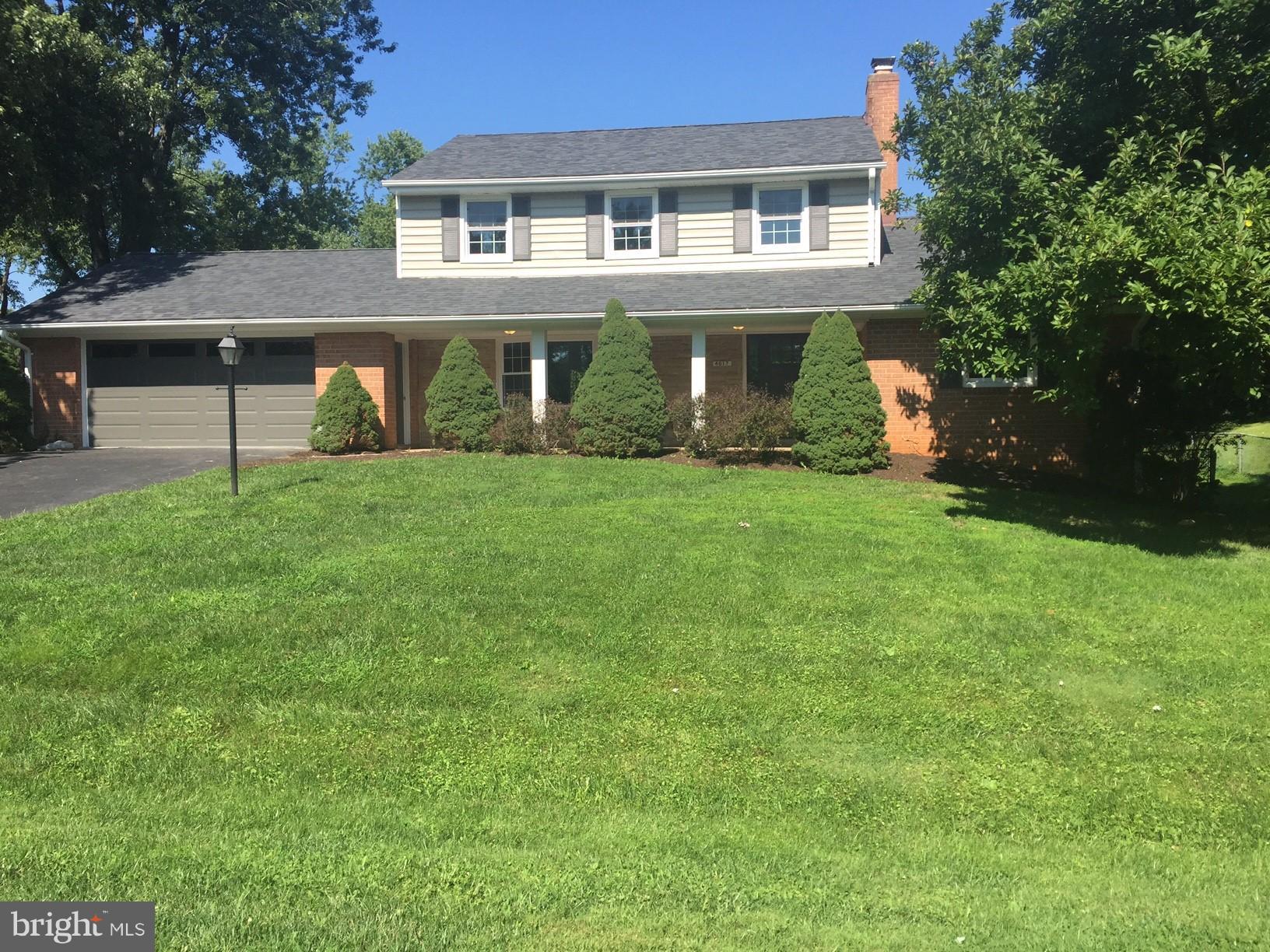 4017 Olney Laytonsville Road Olney, MD 20832 - Photo 1 of 28 a front view of a house with a garden