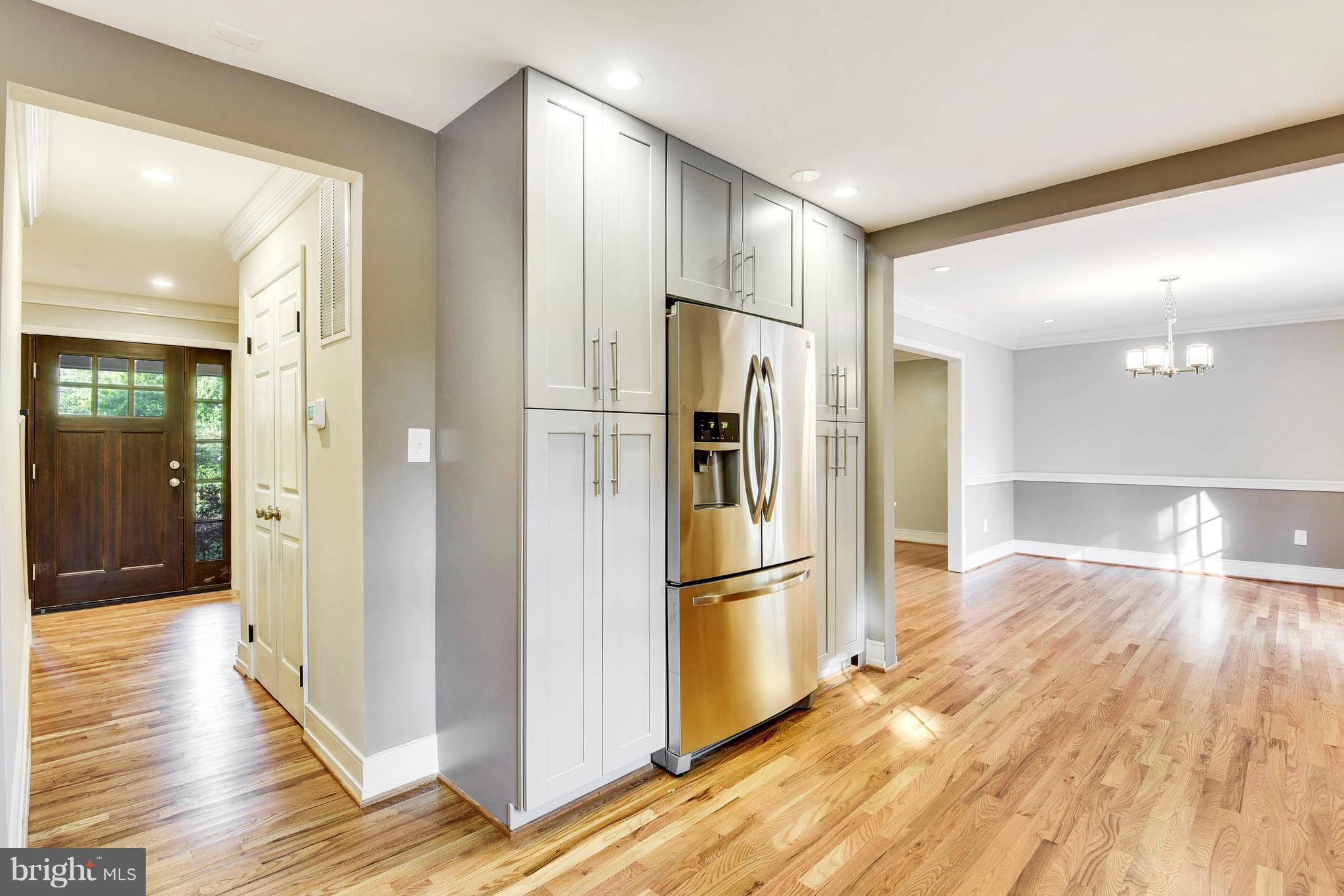 4017 Olney Laytonsville Road Olney, MD 20832 - Photo 3 of 28 a view of a refrigerator in kitchen and wooden floor