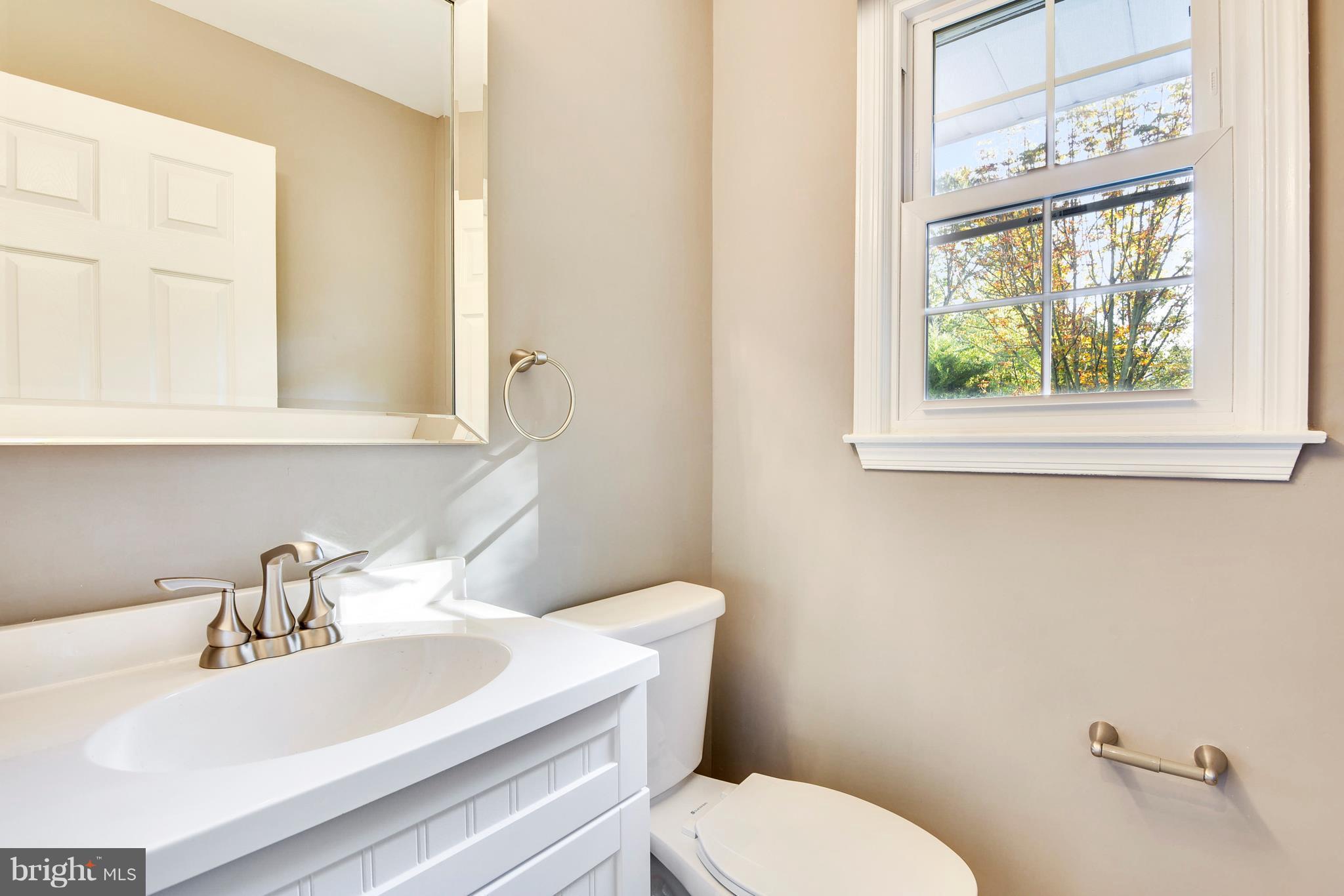 4017 Olney Laytonsville Road Olney, MD 20832 - Photo 24 of 28 a bathroom with a sink a toilet and a window