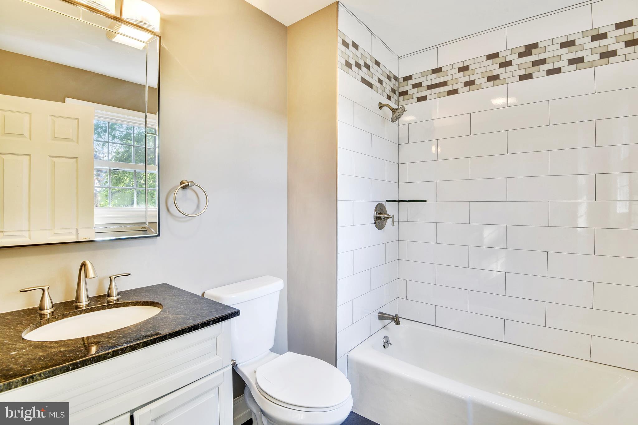 4017 Olney Laytonsville Road Olney, MD 20832 - Photo 25 of 28 a bathroom with a granite countertop sink a toilet and shower