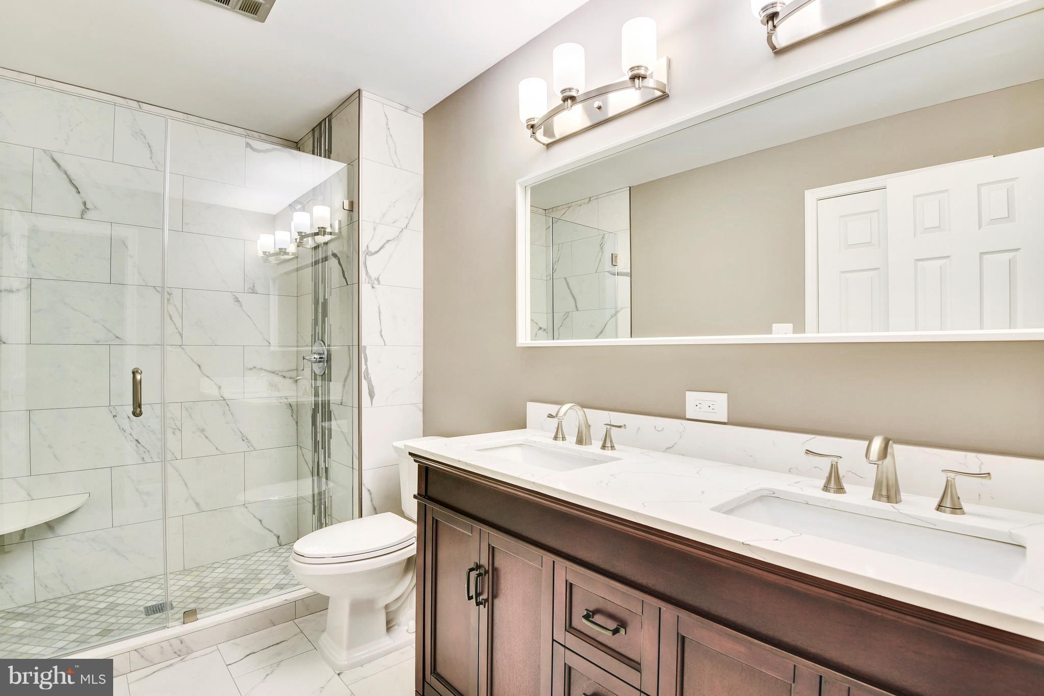 4017 Olney Laytonsville Road Olney, MD 20832 - Photo 26 of 28 a bathroom with a sink a toilet and shower