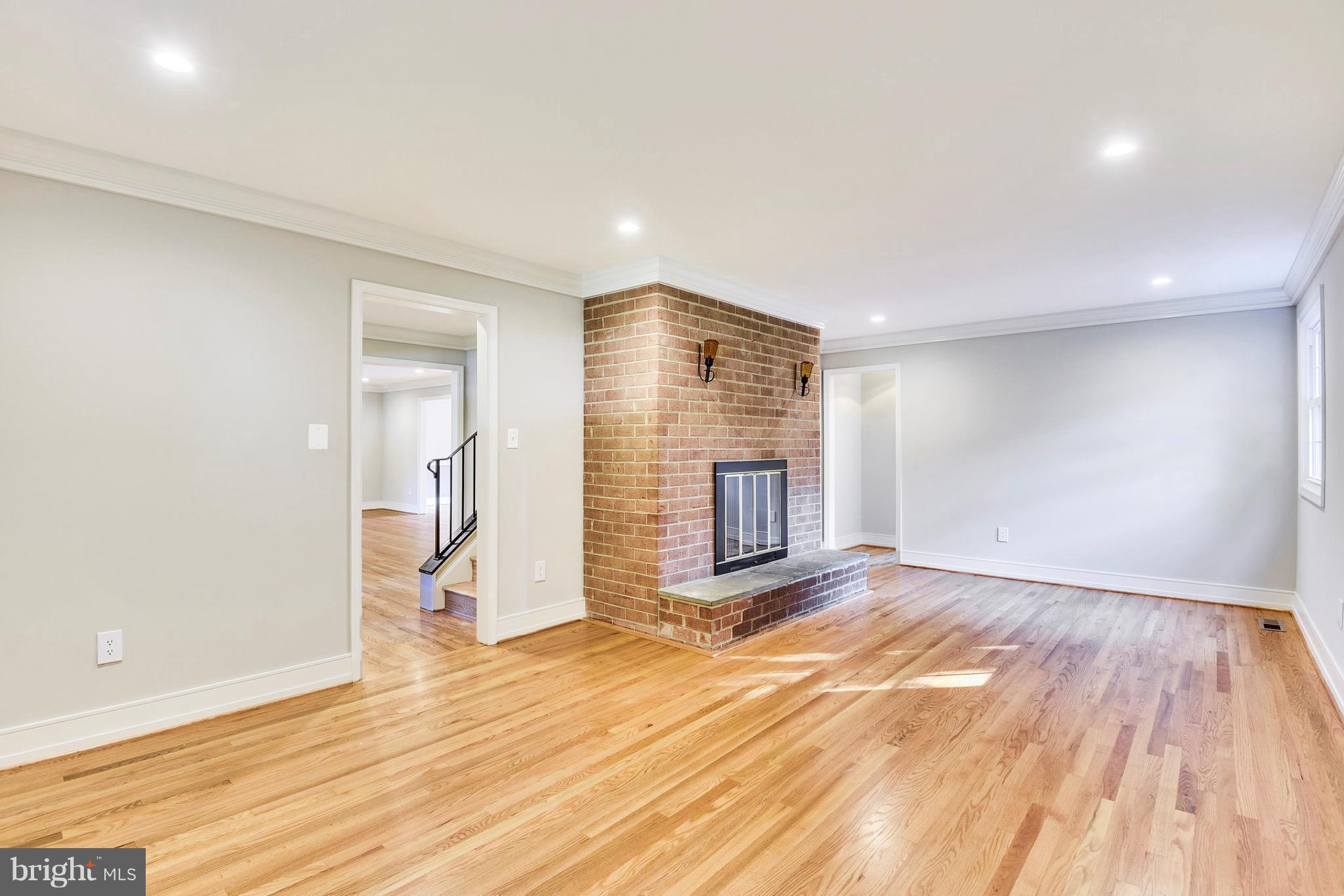 4017 Olney Laytonsville Road Olney, MD 20832 - Photo 7 of 28 a view of empty room with wooden floor and fireplace
