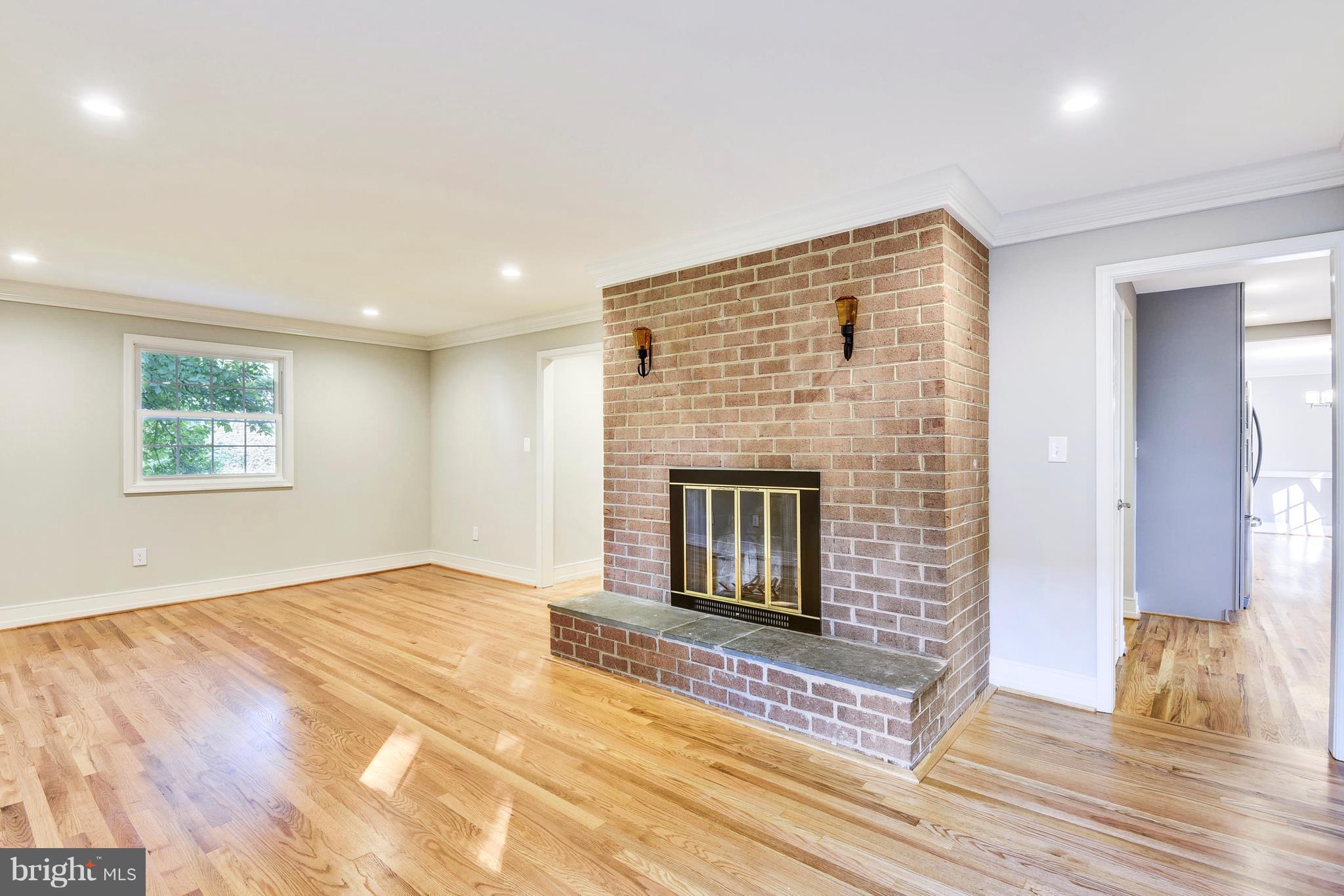 4017 Olney Laytonsville Road Olney, MD 20832 - Photo 8 of 28 a view of a livingroom with wooden floor and a fireplace