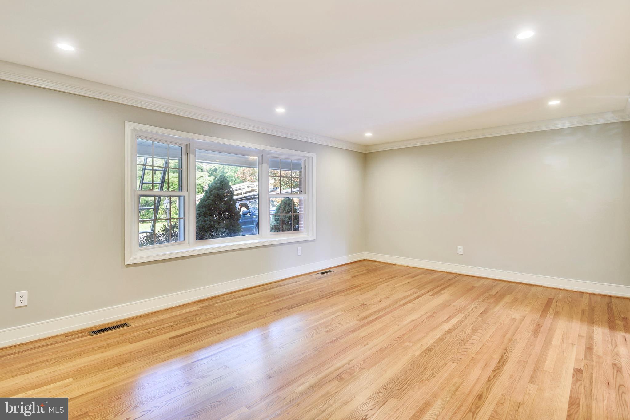 4017 Olney Laytonsville Road Olney, MD 20832 - Photo 9 of 28 a view of an empty room with wooden floor and a window