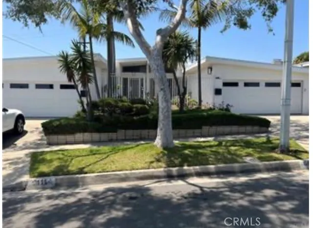 a view of a house with a yard and potted plants