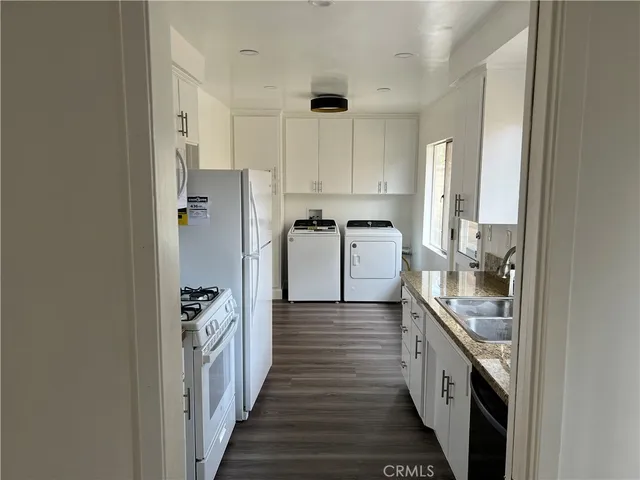 a kitchen with stainless steel appliances granite countertop a refrigerator and a stove