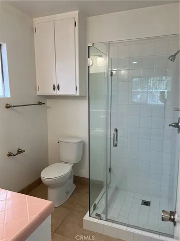 a bathroom with a toilet and a shower