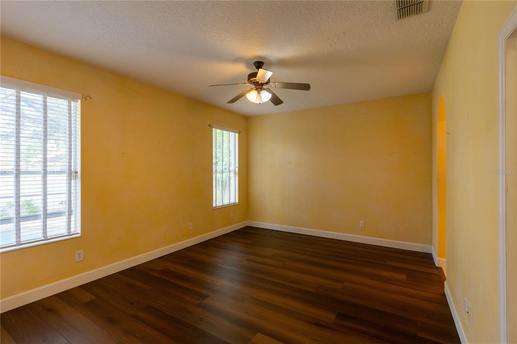 65 Calliope Street Ocoee, FL 34761 - Photo 15 of 60 a view of a room with wooden floor chandelier fan and windows