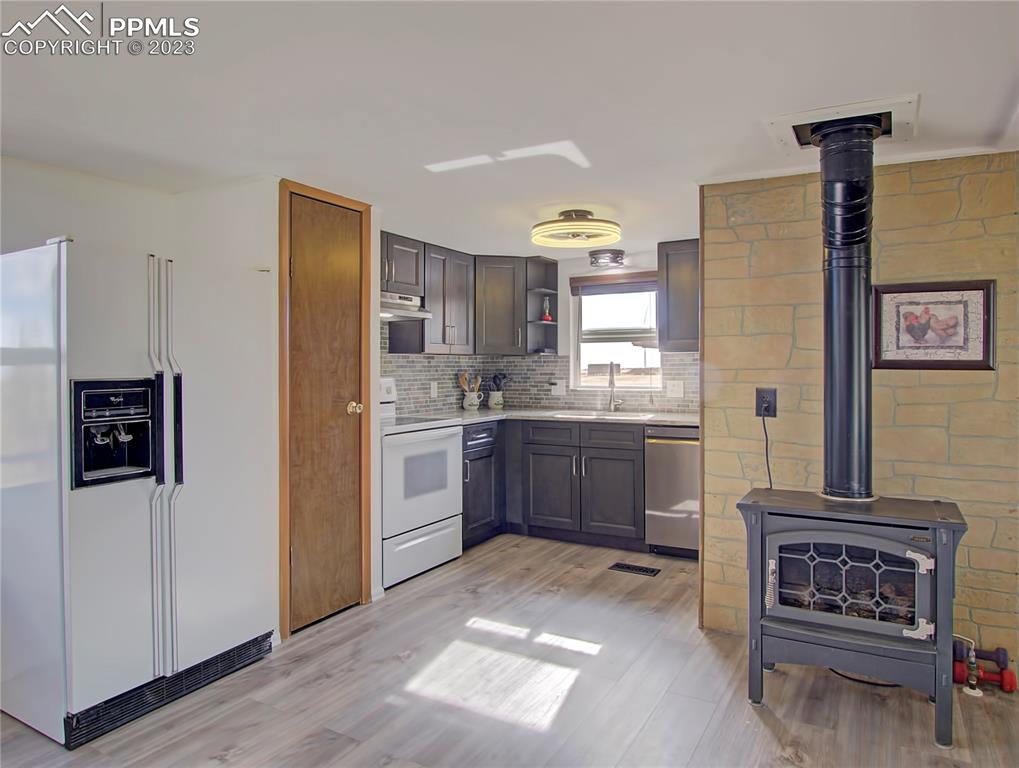 28850 Funk Road Calhan, CO 80808 - Photo 13 of 42 a kitchen with a refrigerator and a stove top oven