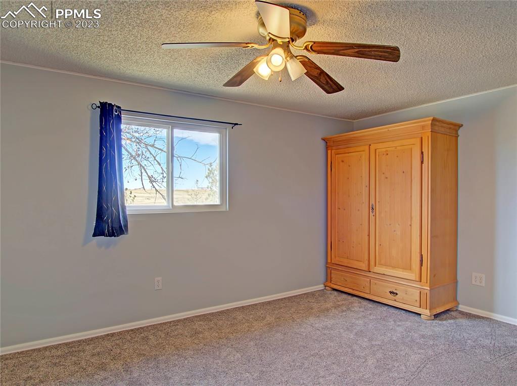 28850 Funk Road Calhan, CO 80808 - Photo 15 of 42 an empty room with windows and fan