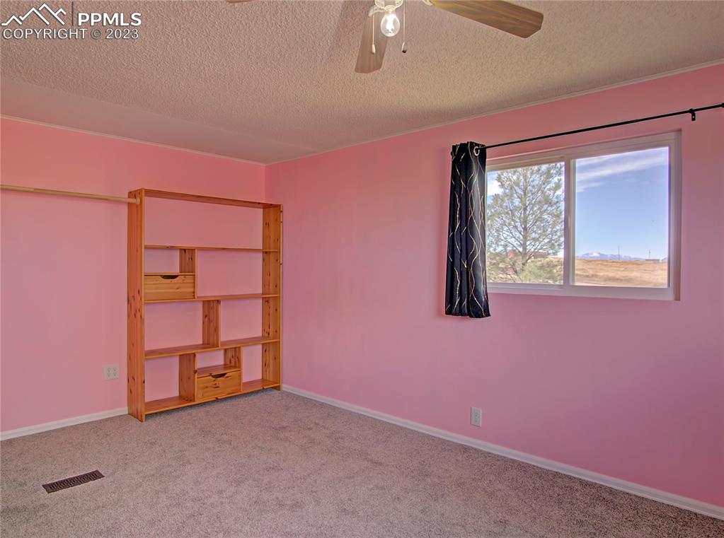 28850 Funk Road Calhan, CO 80808 - Photo 19 of 42 an empty room with windows
