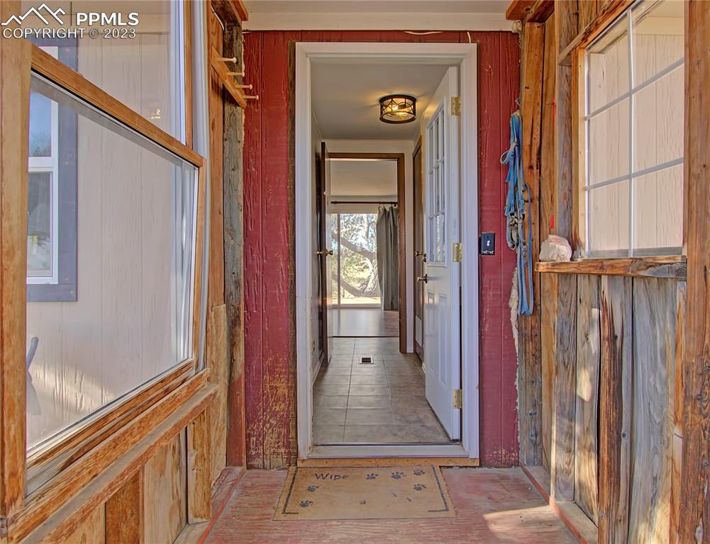28850 Funk Road Calhan, CO 80808 - Photo 5 of 42 a view of a hallway with wooden floor and a living room