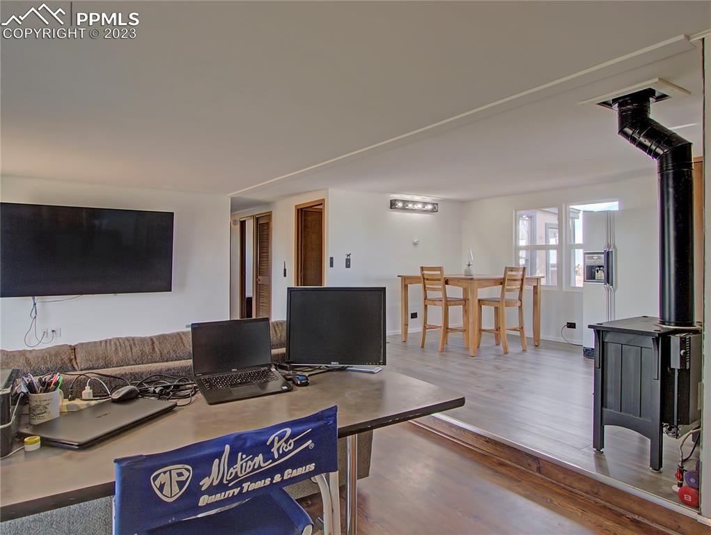 28850 Funk Road Calhan, CO 80808 - Photo 10 of 42 a workspace with furniture and a flat screen tv