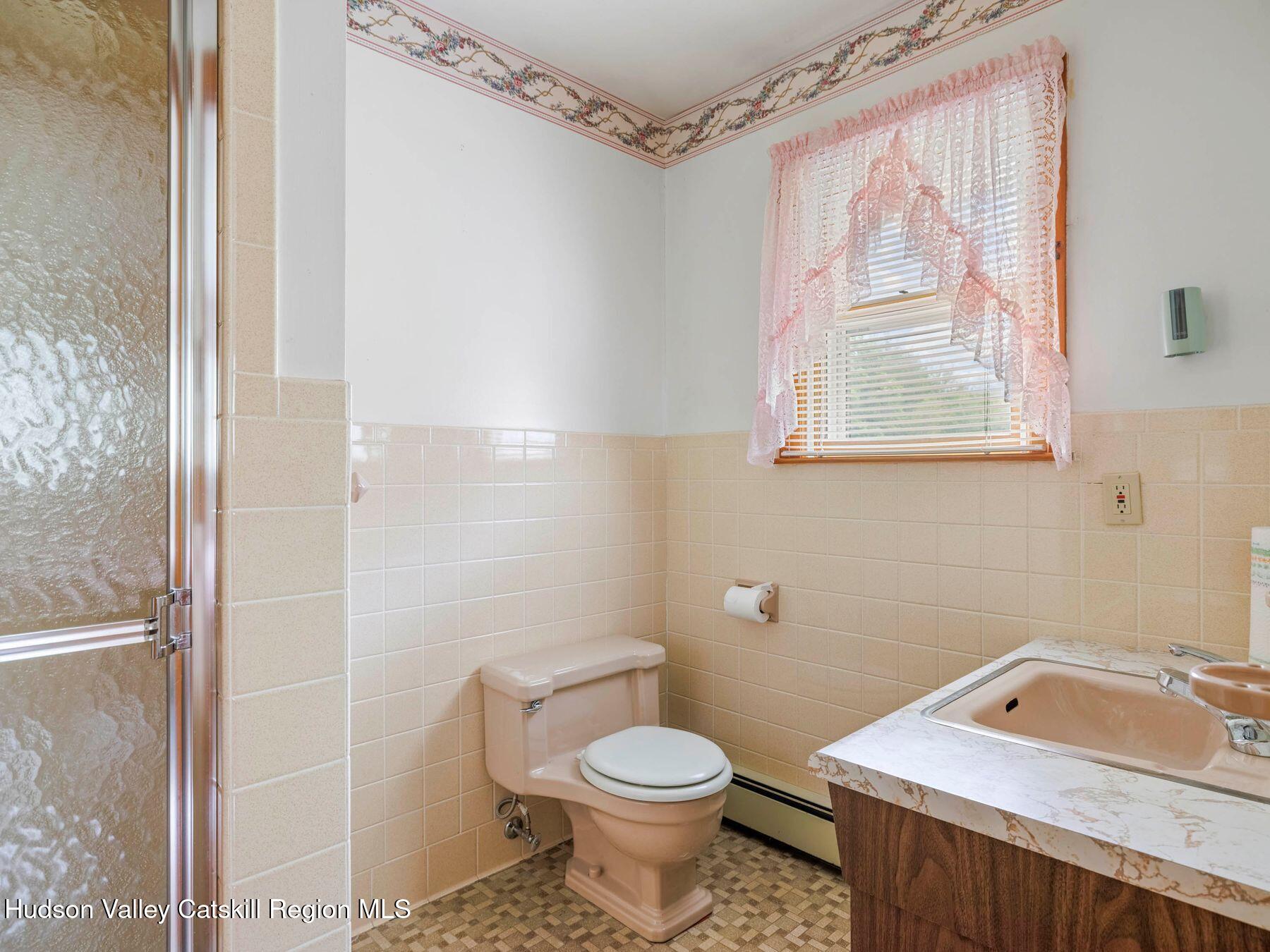 104 New Paltz Road Highland, NY 12528 - Photo 22 of 43 a bathroom with a sink toilet and shower