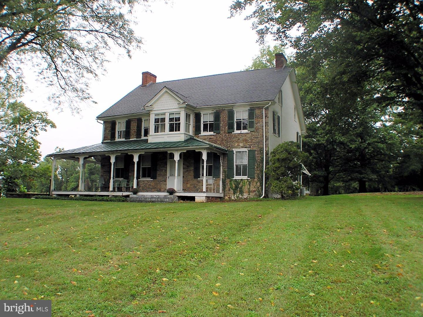 120 Scarlet Road Kennett Square, PA 19348 - Photo 1 of 25 a front view of a house with a garden and trees