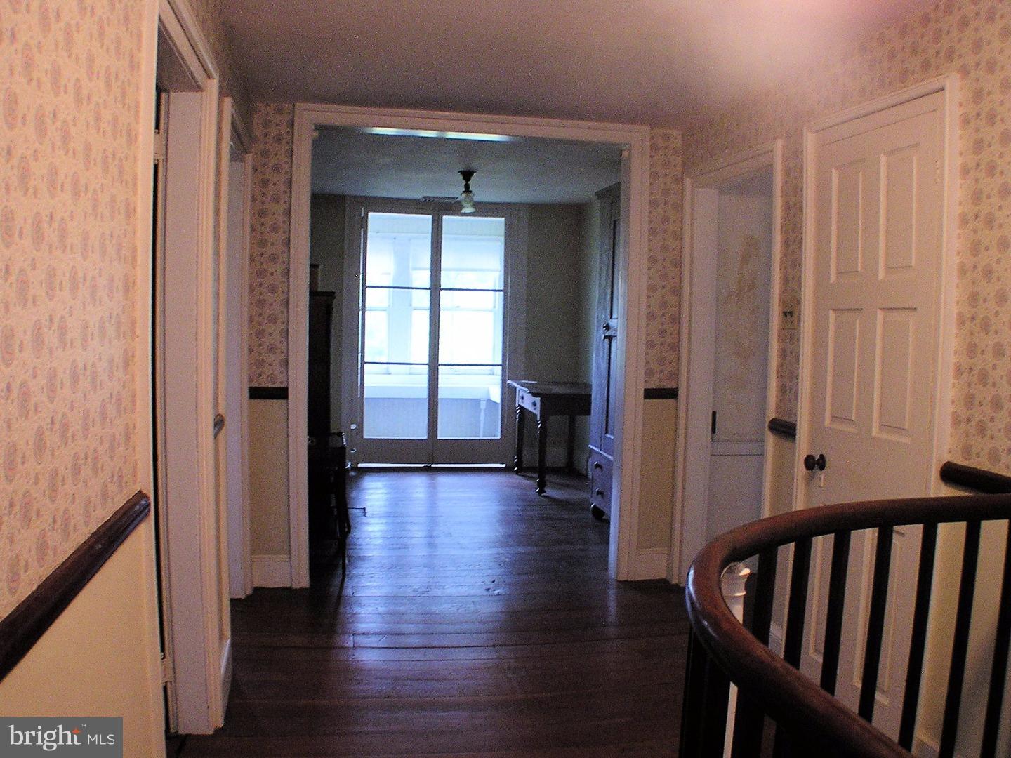 120 Scarlet Road Kennett Square, PA 19348 - Photo 13 of 25 a view of a hallway with wooden floor and stairs