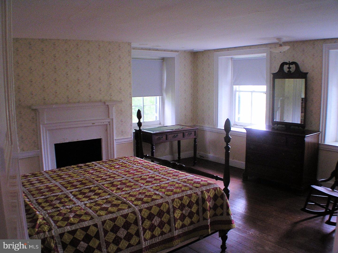 120 Scarlet Road Kennett Square, PA 19348 - Photo 15 of 25 a bedroom with a bed and a fireplace