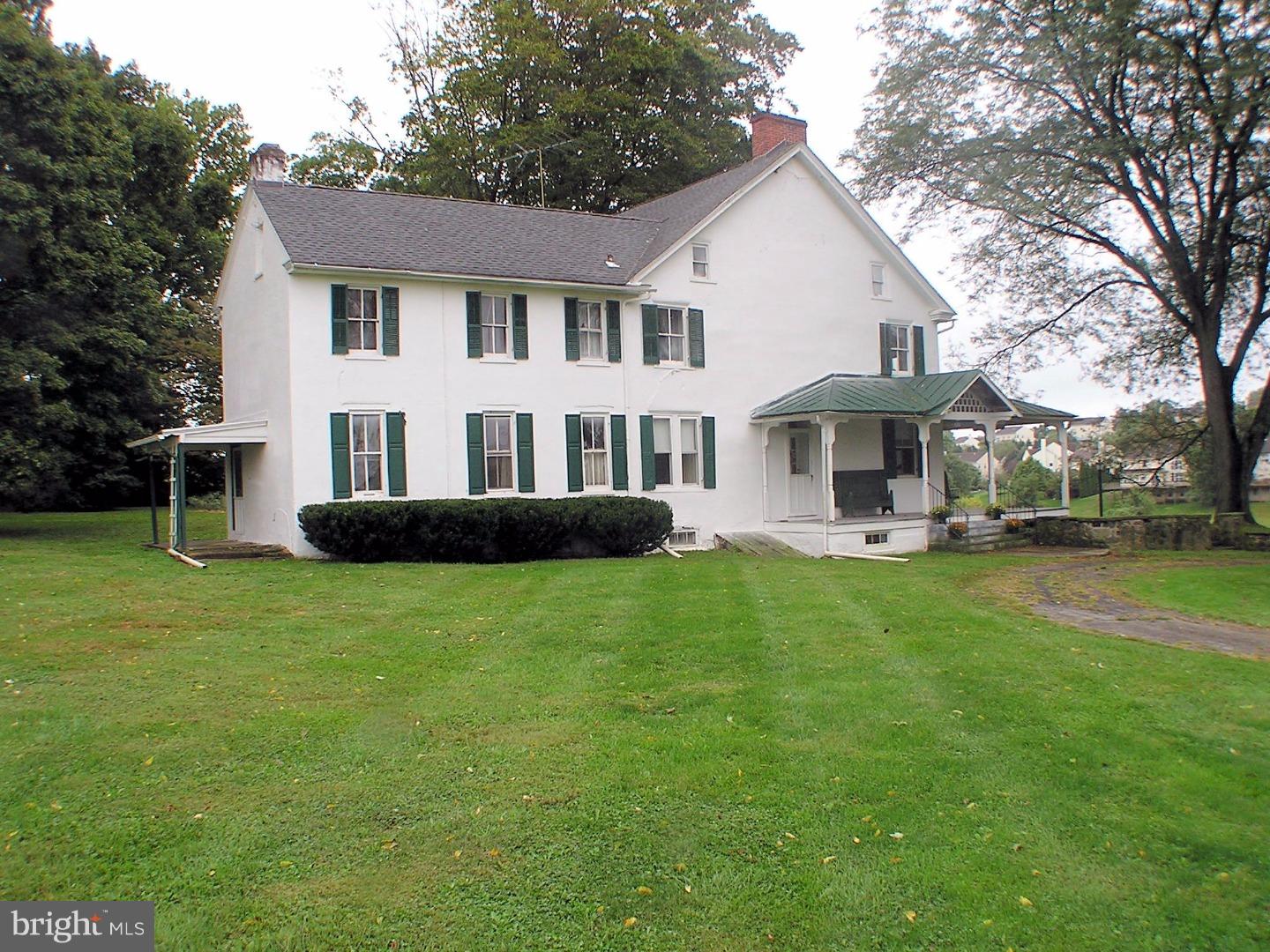 120 Scarlet Road Kennett Square, PA 19348 - Photo 4 of 25 a front view of a house with a garden and trees