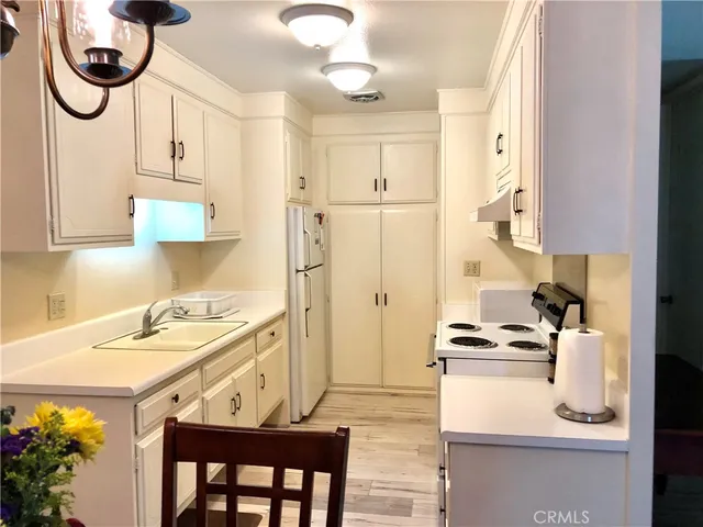 a kitchen with stainless steel appliances granite countertop a sink a stove and a refrigerator