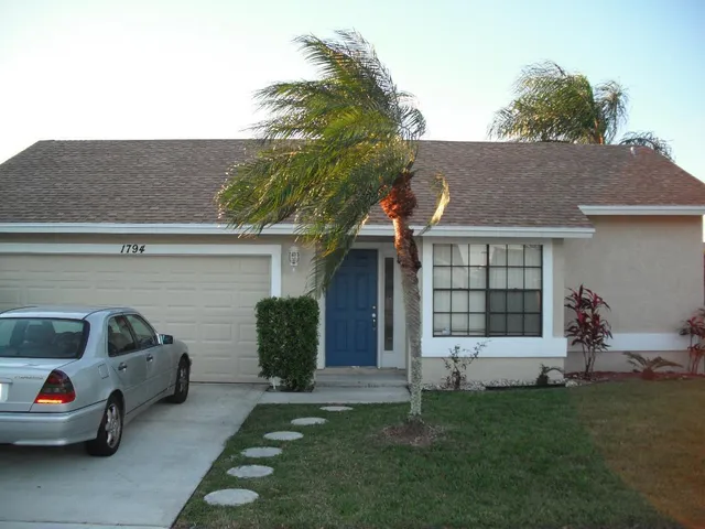 a view of a car parked in front of a house