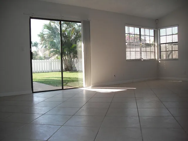 a view of an empty room with a floor to ceiling window
