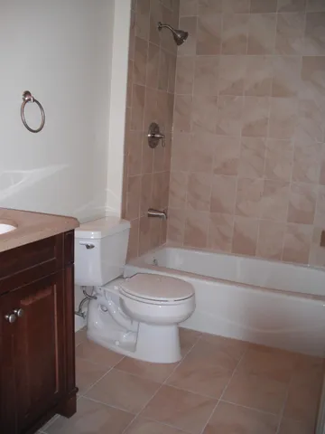 a bathroom with a toilet a sink and shower