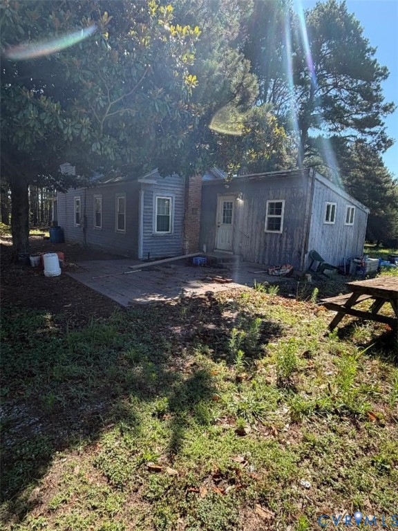 5717 Colonial Trail West Spring Grove, VA 23881 - Photo 2 of 3 Gray siding exterior with multiple windows, a bric