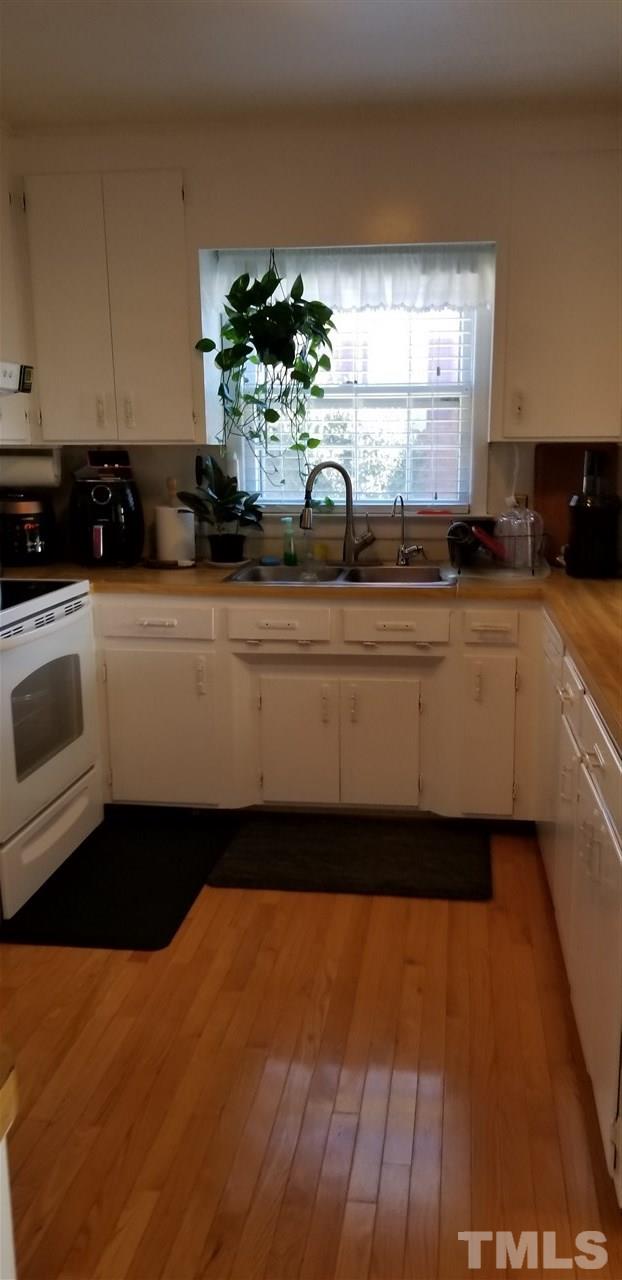 3909 Buffaloe Road Raleigh, NC 27604 - Photo 2 of 11 a kitchen with a sink and cabinets