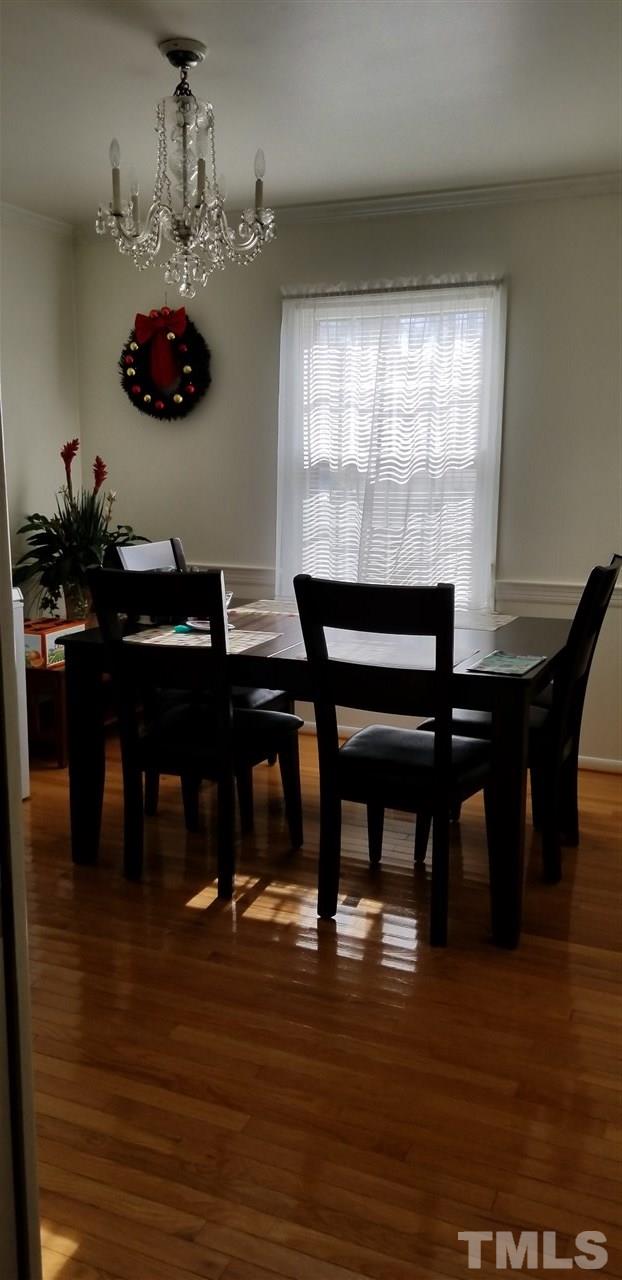 3909 Buffaloe Road Raleigh, NC 27604 - Photo 5 of 11 a view of a dining room with furniture and wooden floor