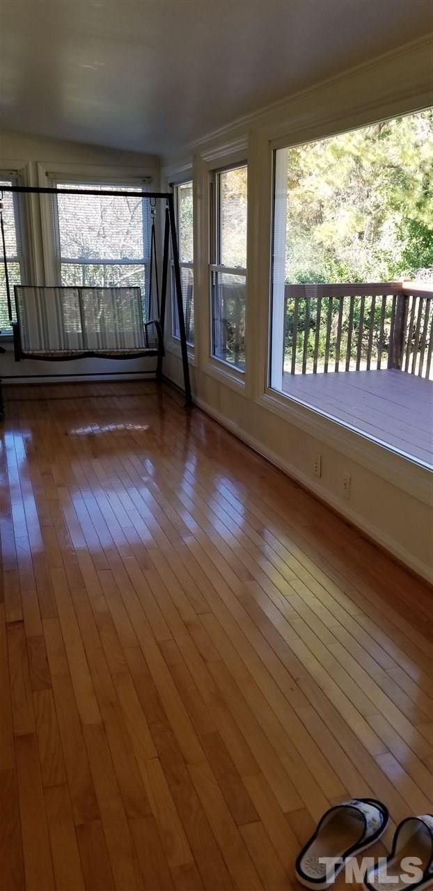 3909 Buffaloe Road Raleigh, NC 27604 - Photo 6 of 11 an empty room with wooden floor and windows