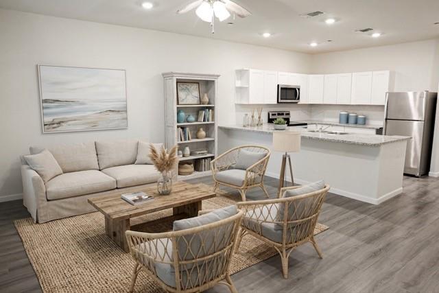 802 South 5th Street, Unit 1 Bonham, TX 75418 - Photo 13 of 25 Open-concept living space with wood-finish flooring, recessed lighting, and a ceiling fan