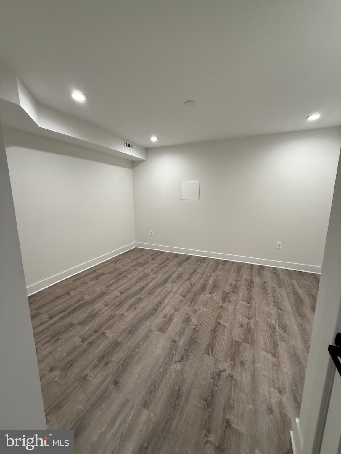 3923 Roland Avenue Baltimore, MD 21211 - Photo 11 of 13 an empty room with wooden floor and windows
