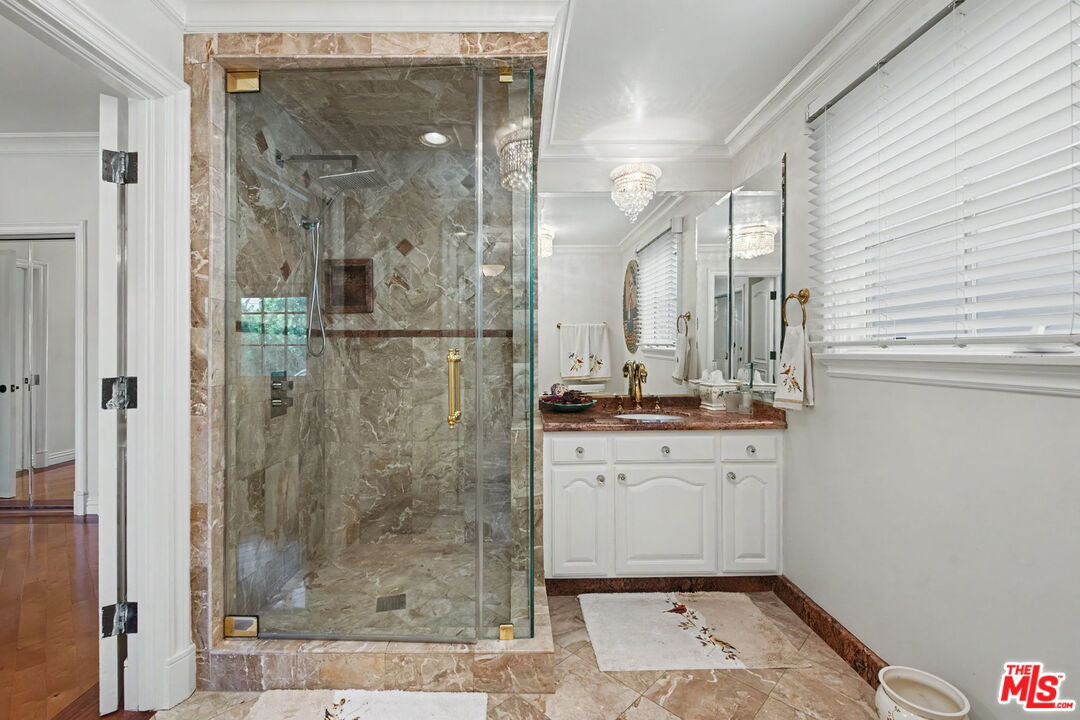 204 Foothill Road Beverly Hills, CA 90210 - Photo 19 of 38 a bathroom with a shower and a sink