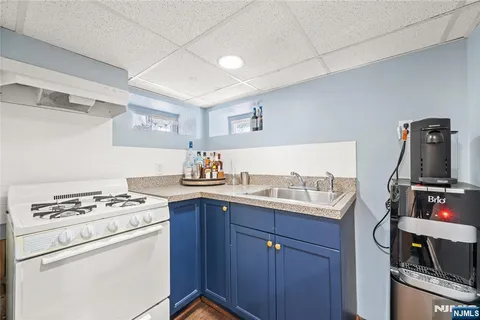 a kitchen with granite countertop a sink stove and cabinets