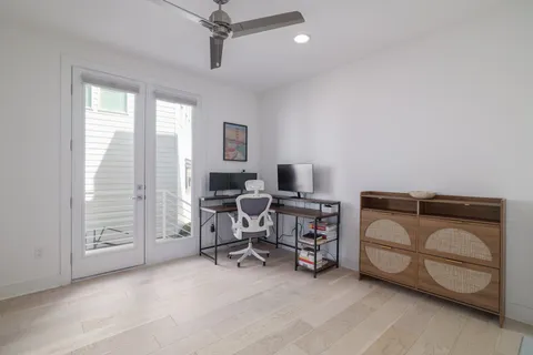a view of a livingroom with workspace and a window