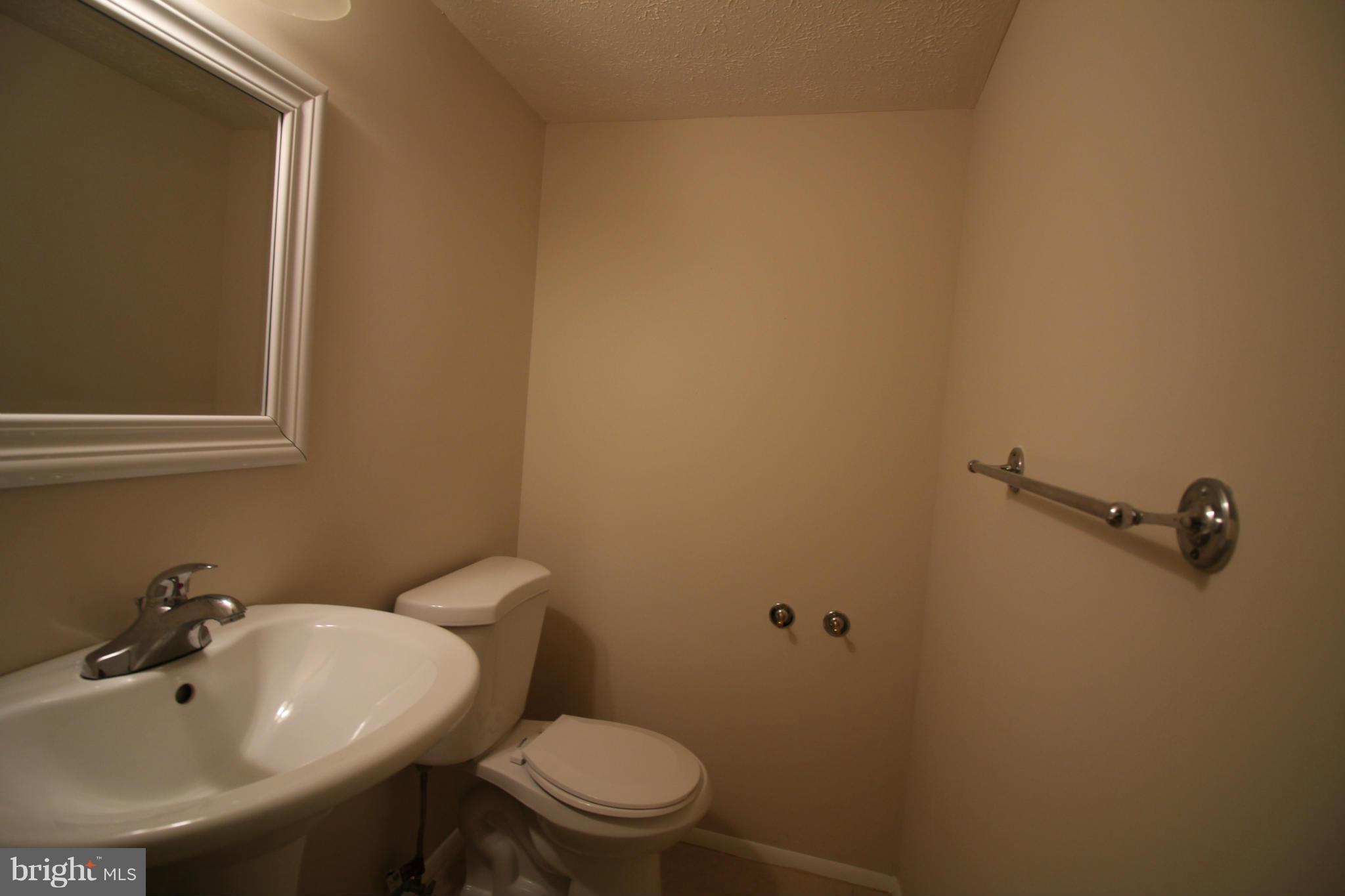 6266 Hillside Road Springfield, VA 22152 - Photo 14 of 29 a bathroom with a sink and mirror with toilet